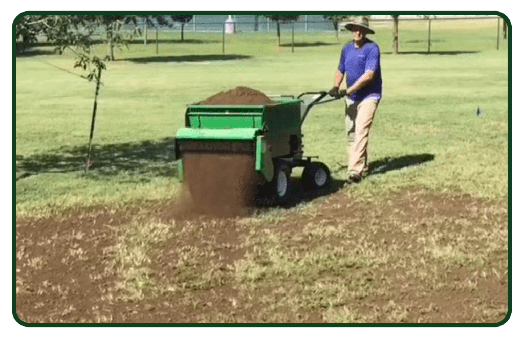 A man is using a lawn seed spreader.